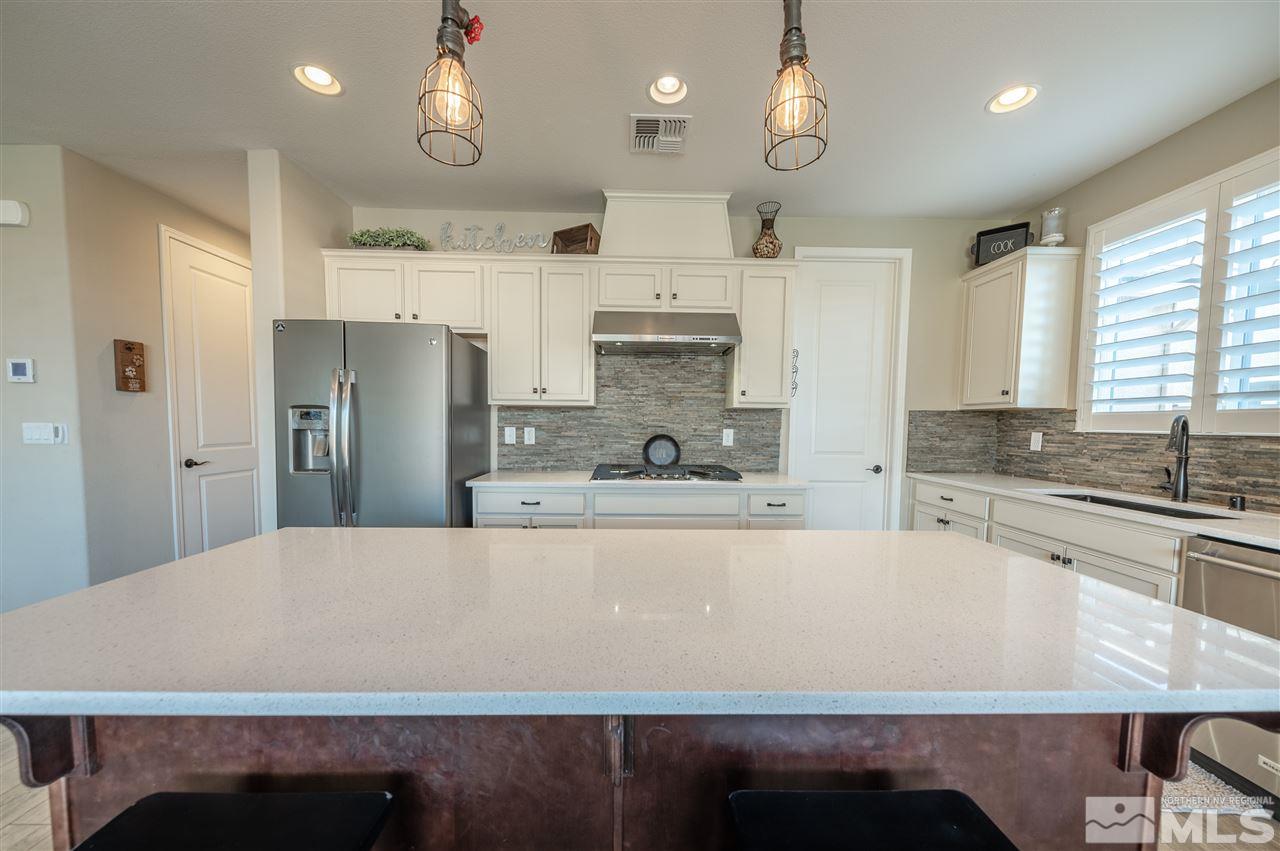 2935 Bonfire Lane Reno, NV 89521 - Photo 14 of 39 a large kitchen with stainless steel appliances a large counter top a stove and a refrigerator