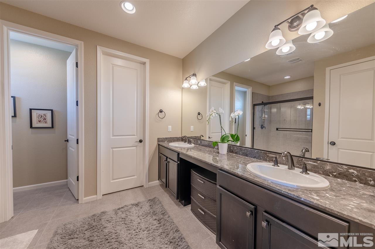 2935 Bonfire Lane Reno, NV 89521 - Photo 18 of 39 a bathroom with a granite countertop double vanity sink and a mirror