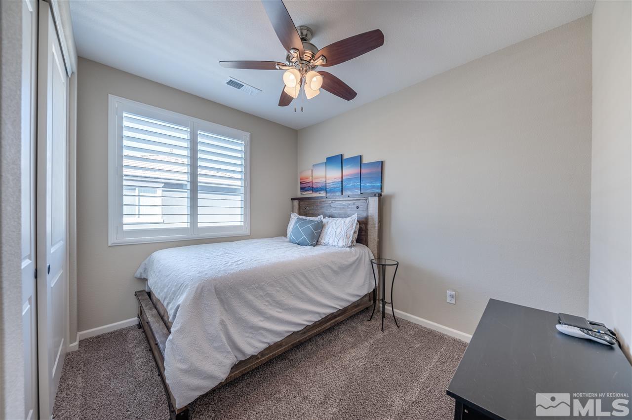 2935 Bonfire Lane Reno, NV 89521 - Photo 20 of 39 a bedroom with a bed and a ceiling fan