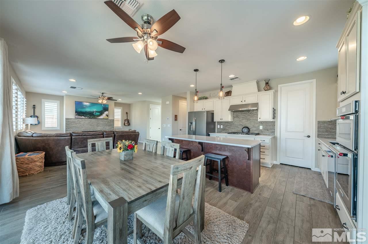 2935 Bonfire Lane Reno, NV 89521 - Photo 2 of 39 a kitchen with stainless steel appliances granite countertop a table chairs and a refrigerator