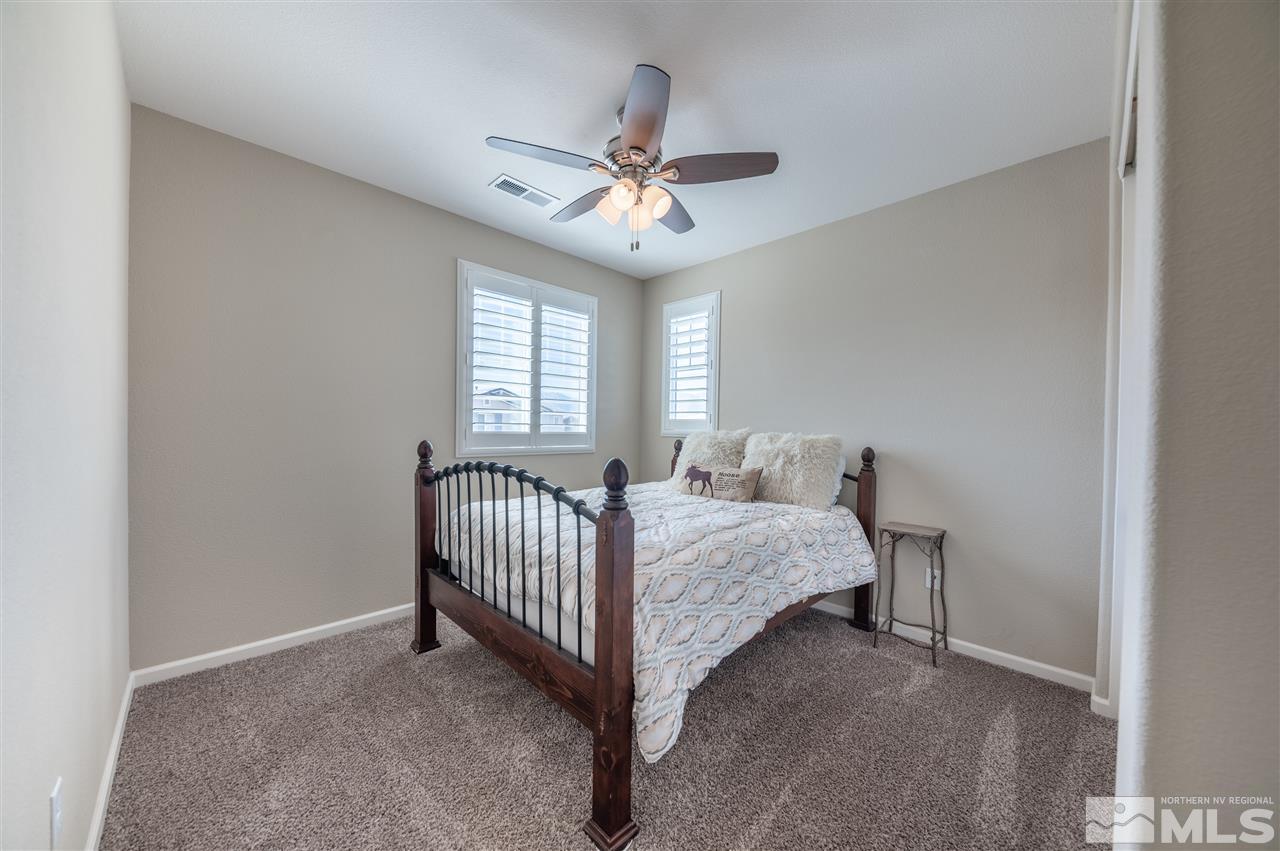 2935 Bonfire Lane Reno, NV 89521 - Photo 23 of 39 a bed room with a bed and a chandelier