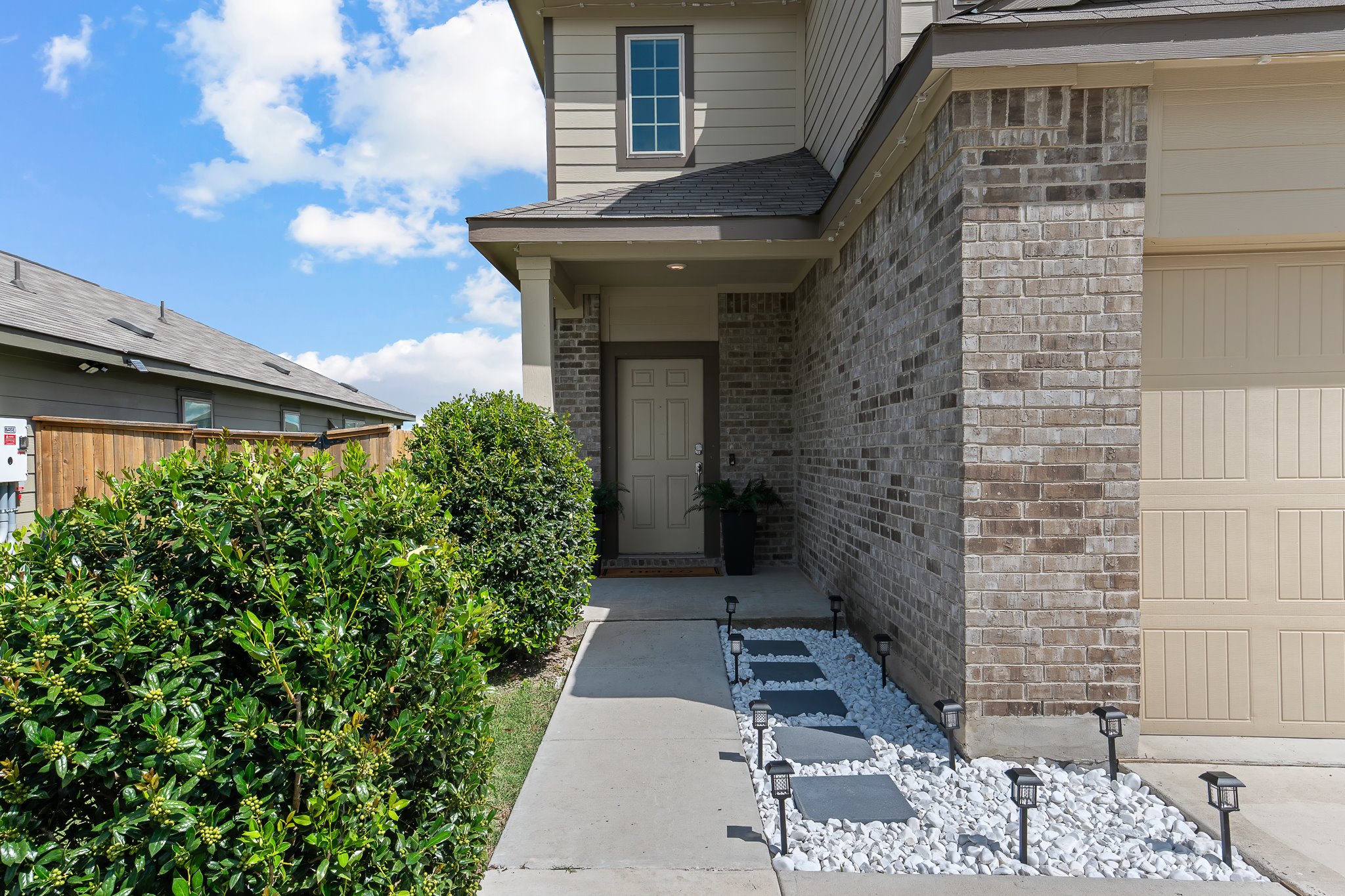 576 Greatest Gift Way Jarrell, TX 76537 - Photo 3 of 37 Brick and siding facade with welcoming entry, showcasing tidy landscaping.