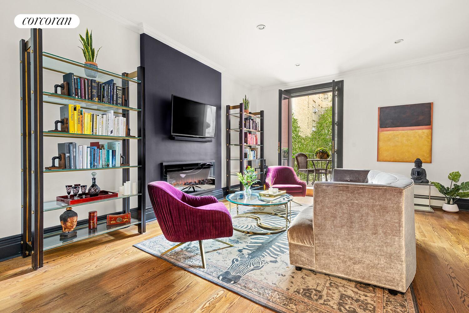 124 West 87th Street Manhattan, NY 10024 - Photo 18 of 37 a living room with fireplace furniture and a flat screen tv