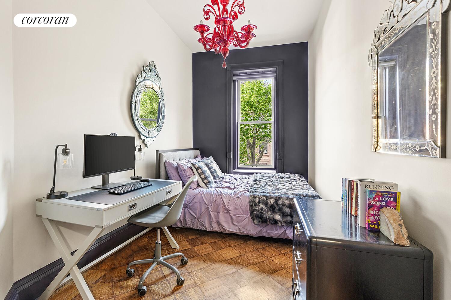 124 West 87th Street Manhattan, NY 10024 - Photo 24 of 37 a bedroom with a bed window and a table