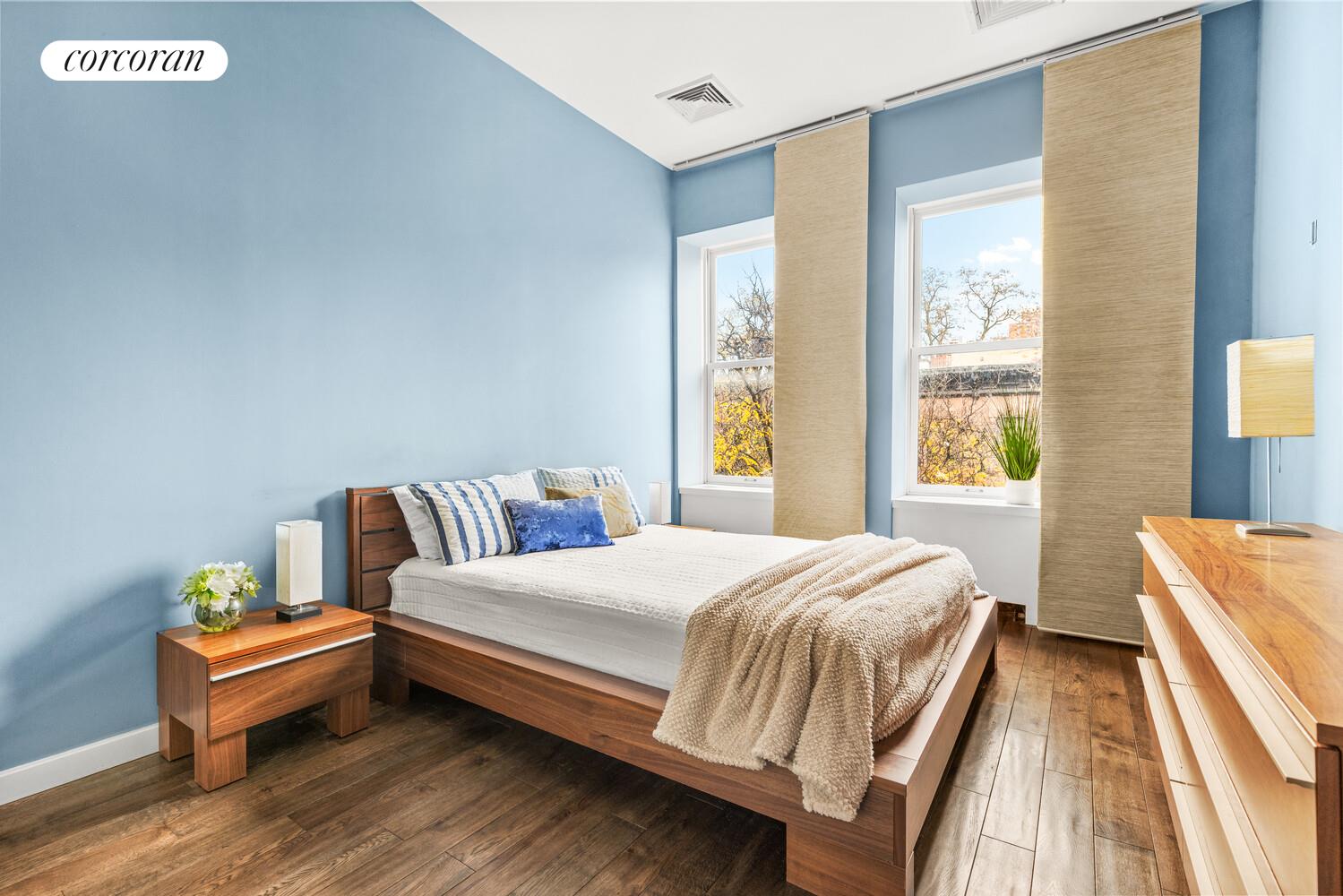 124 West 87th Street Manhattan, NY 10024 - Photo 32 of 37 a bedroom with a bed and wooden floor