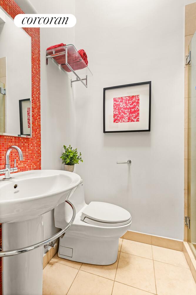 124 West 87th Street Manhattan, NY 10024 - Photo 35 of 37 a bathroom with a sink a toilet and a shower curtain