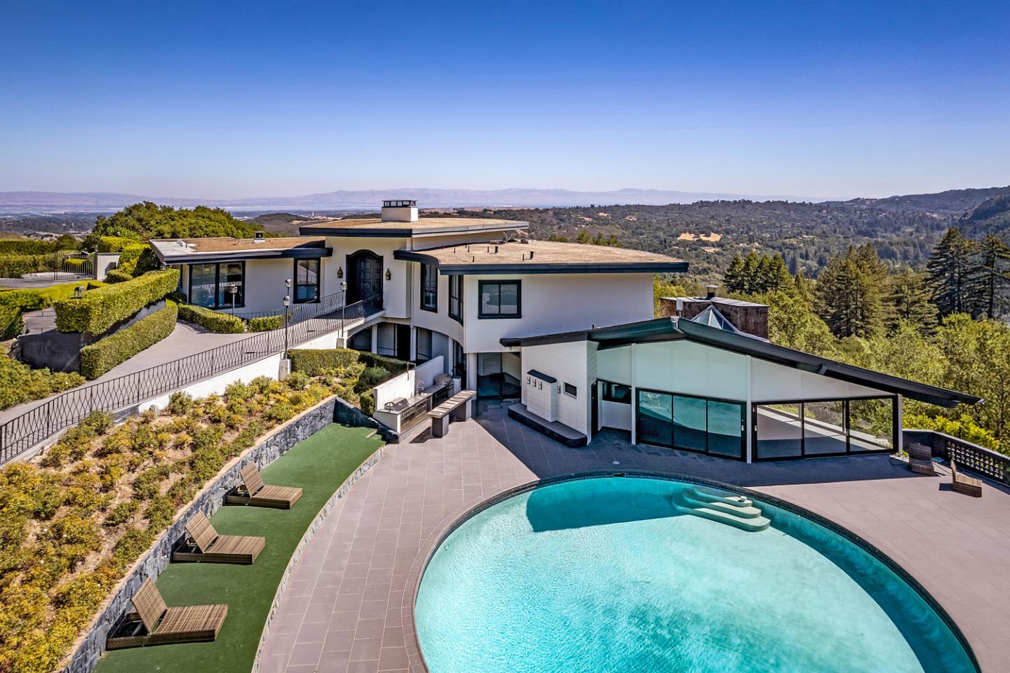 an aerial view of a house with swimming pool outdoor seating