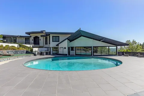 a front view of a house with swimming pool