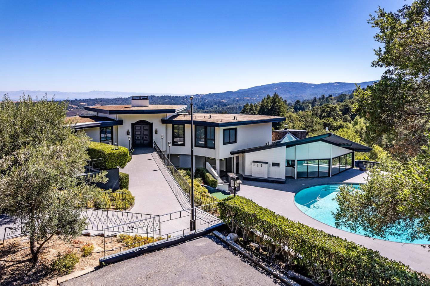 835 La Honda Road Woodside, CA 94062 - Photo 3 of 26 an aerial view of a house with swimming pool and glass doors
