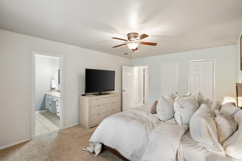 1520 Timbercreek Road Benbrook, TX 76126 - Photo 21 of 30 a bedroom with a bed and a chandelier