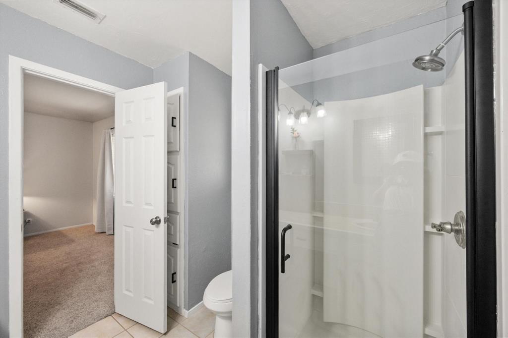 1520 Timbercreek Road Benbrook, TX 76126 - Photo 23 of 30 a bathroom with a glass shower door