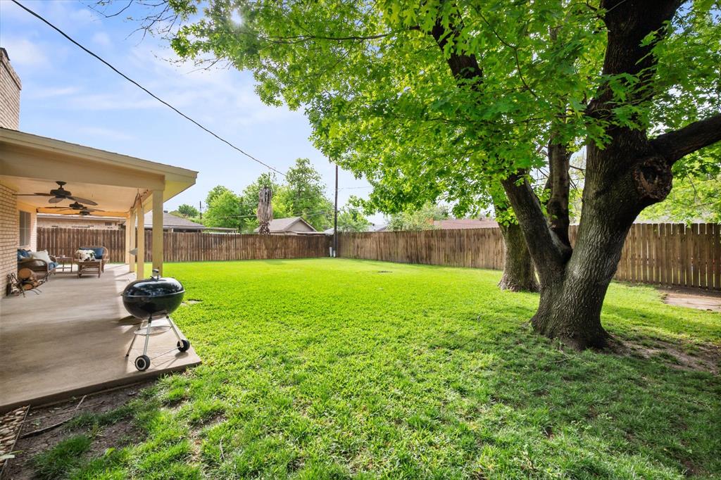 1520 Timbercreek Road Benbrook, TX 76126 - Photo 28 of 30 a view of backyard with a barn and large trees