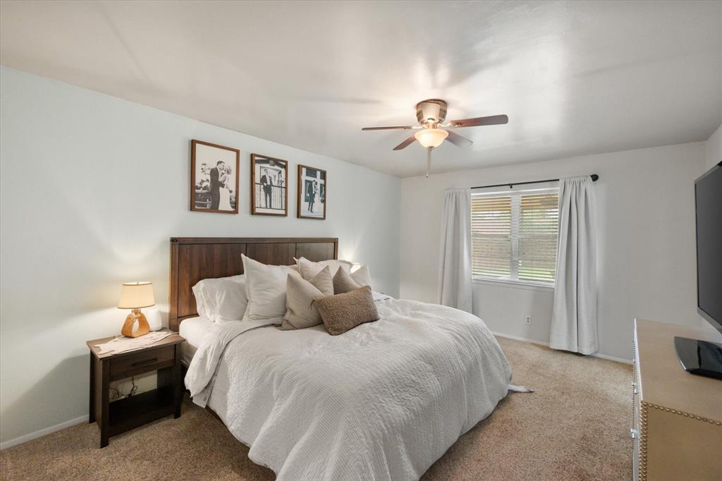 1520 Timbercreek Road Benbrook, TX 76126 - Photo 4 of 30 a bedroom with a bed and a chandelier