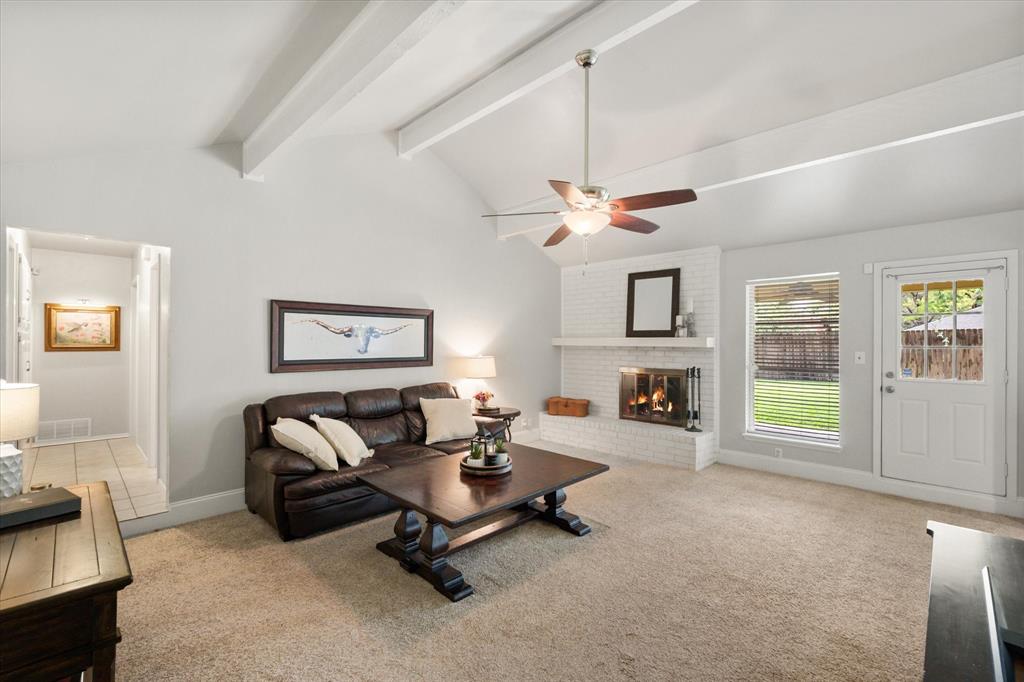 1520 Timbercreek Road Benbrook, TX 76126 - Photo 8 of 30 a living room with furniture a fireplace and a window