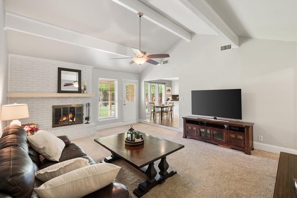 1520 Timbercreek Road Benbrook, TX 76126 - Photo 10 of 30 a living room with furniture a flat screen tv and a fireplace