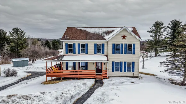 a wooden bench sitting in front of a house