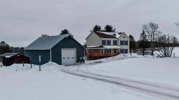 a view of a house with a snow in the road