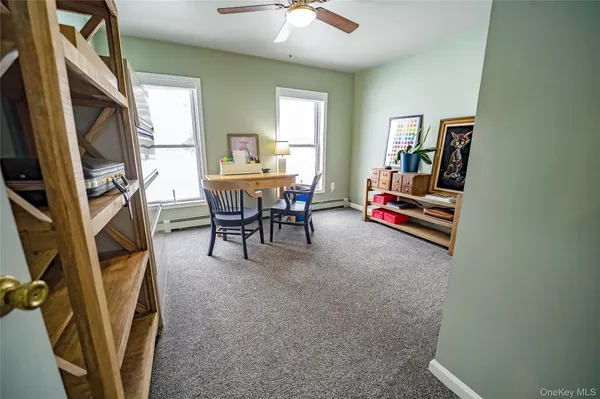 a view of a closet with wooden floor and chair