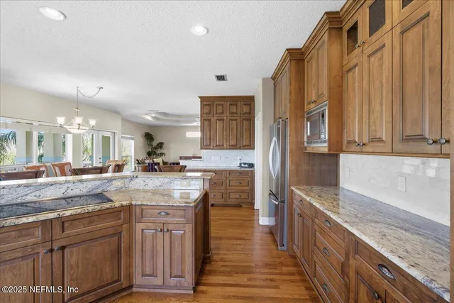 a view of a patio with a table chairs and a backyard