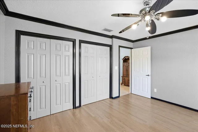 a living room with furniture a ceiling fan and a rug