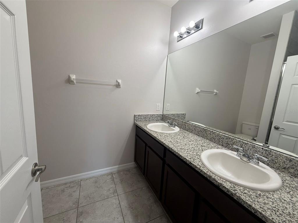 24484 Zephyr Court Punta Gorda, FL 33983 - Photo 14 of 22 a bathroom with a granite countertop sink and a mirror
