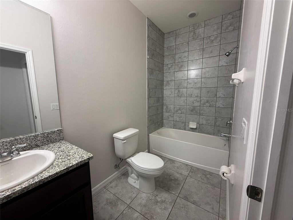 24484 Zephyr Court Punta Gorda, FL 33983 - Photo 16 of 22 a bathroom with a granite countertop sink toilet and shower