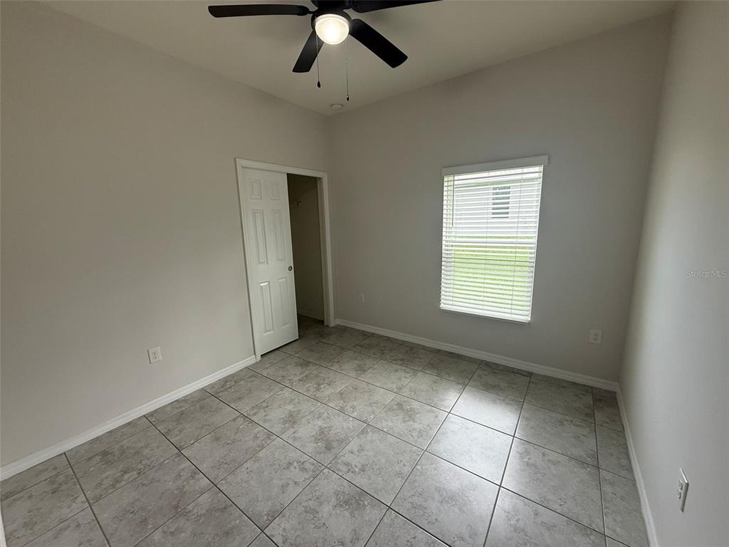 24484 Zephyr Court Punta Gorda, FL 33983 - Photo 18 of 22 an empty room with a ceiling fan and window