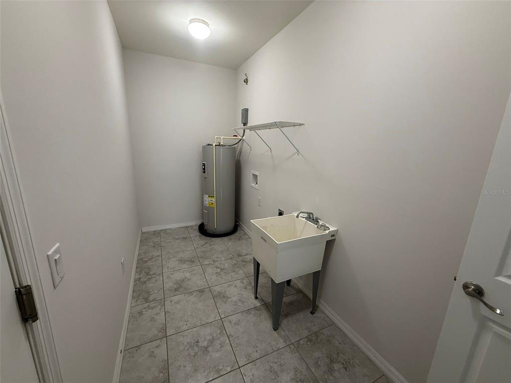 24484 Zephyr Court Punta Gorda, FL 33983 - Photo 20 of 22 a view of a storage and utility room with a sink