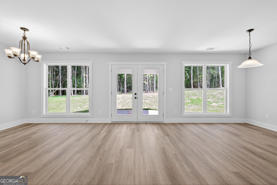 206 Airport Road, Unit 11 Canon, GA 30520 - Photo 15 of 34 a view of an empty room with wooden floor and a window