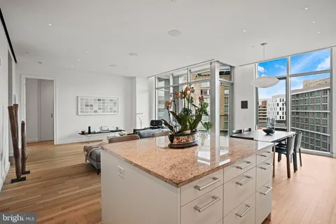 a kitchen with a table chairs stove and cabinets