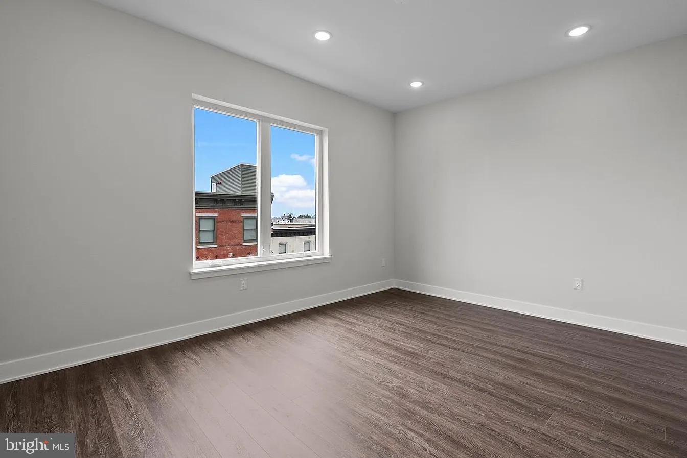 2146 North Front Street, Unit 3 Philadelphia, PA 19122 - Photo 19 of 23 a view of an empty room with wooden floor and a window