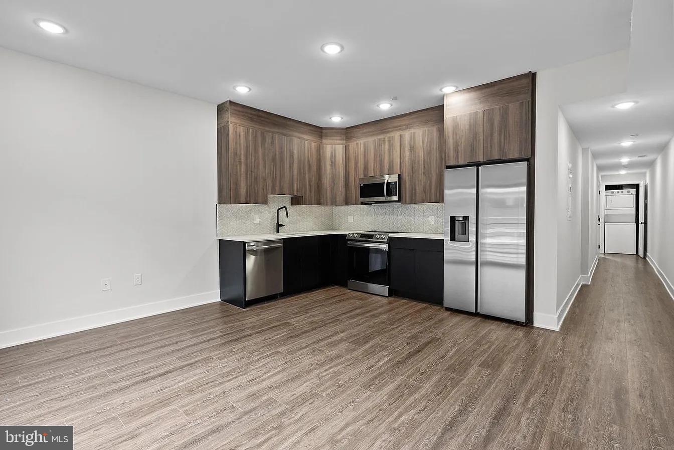 2146 North Front Street, Unit 3 Philadelphia, PA 19122 - Photo 3 of 23 a kitchen with stainless steel appliances granite countertop a stove a sink and a refrigerator