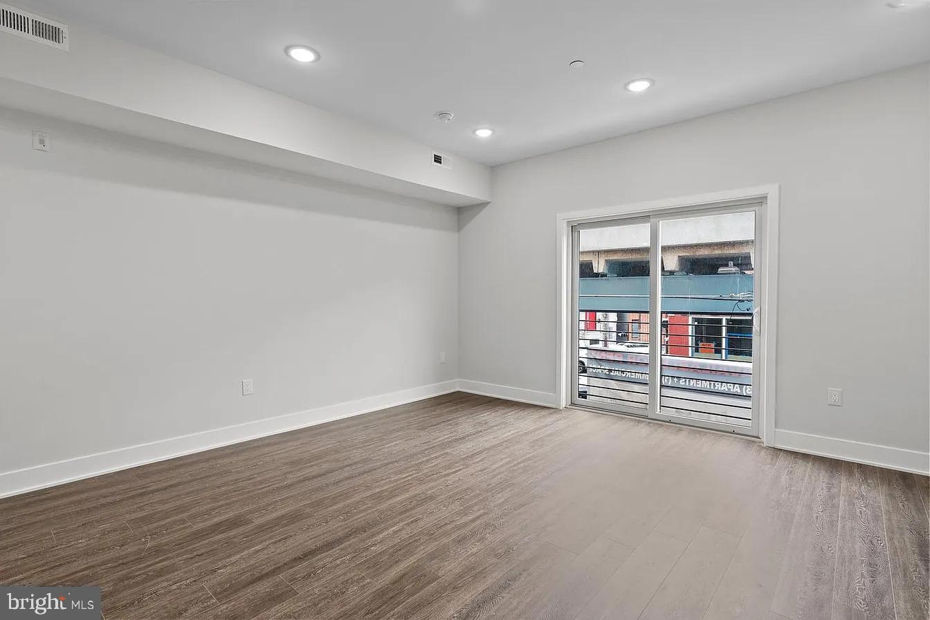 2146 North Front Street, Unit 3 Philadelphia, PA 19122 - Photo 9 of 23 an empty room with wooden floor and entrance
