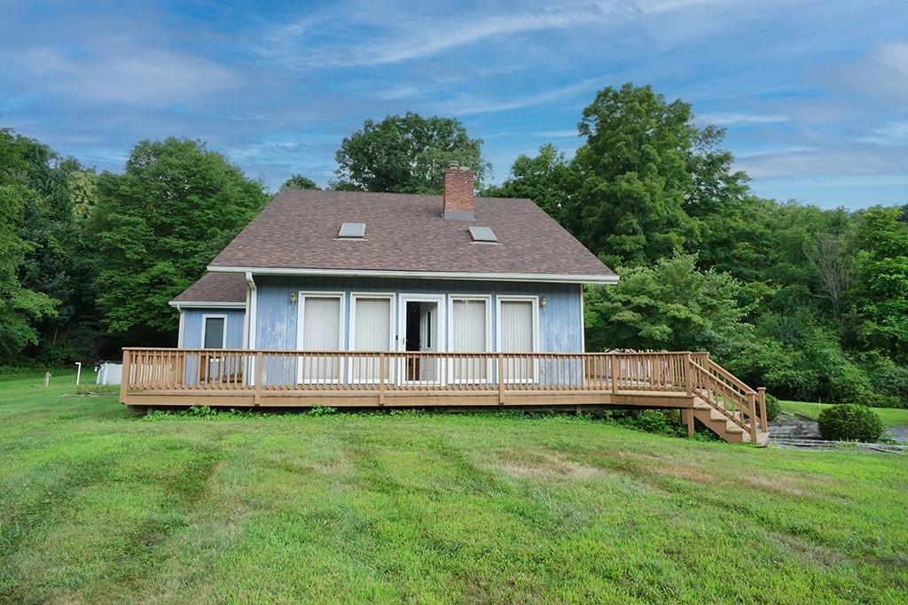 a aerial view of a house with a yard table and chairs