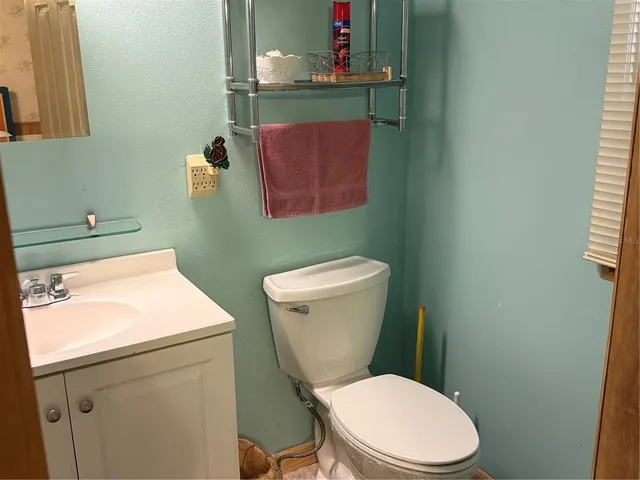 a bed room with a bed and a chair