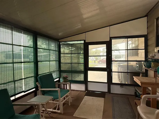 a front view of a house with a garden and trees