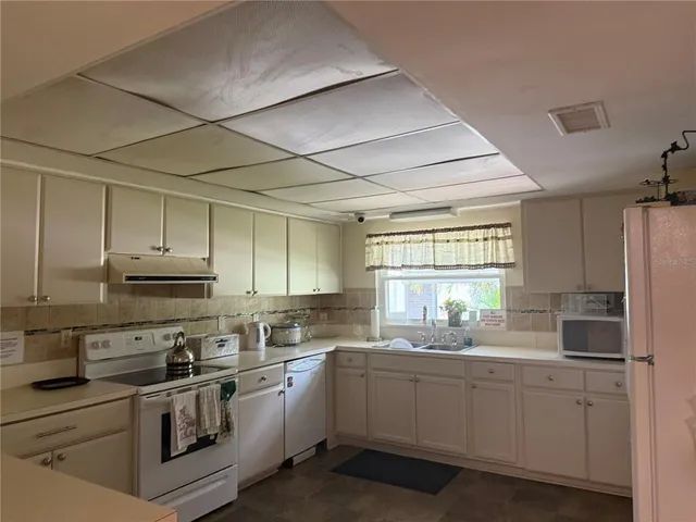 a view of a house with swimming pool and sitting area