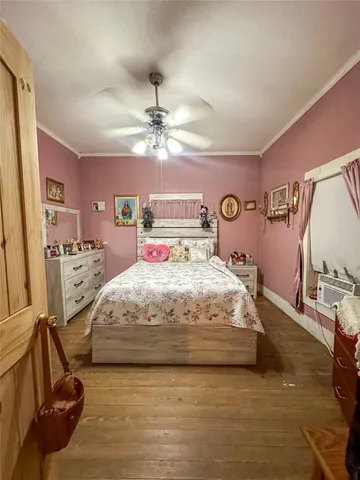 a spacious bedroom with a bed and ceiling fan