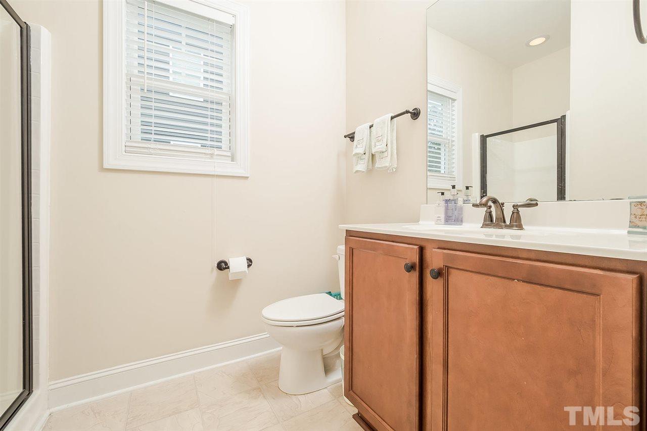 4436 Glengrove Road Raleigh, NC 27616 - Photo 13 of 25 a bathroom with a sink a toilet and a mirror
