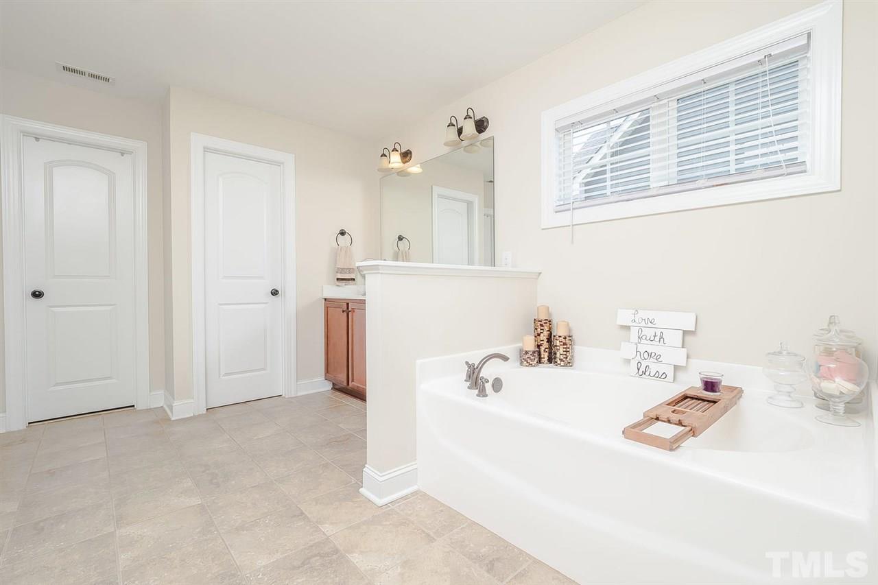 4436 Glengrove Road Raleigh, NC 27616 - Photo 17 of 25 a bathroom with a sink and a bathtub