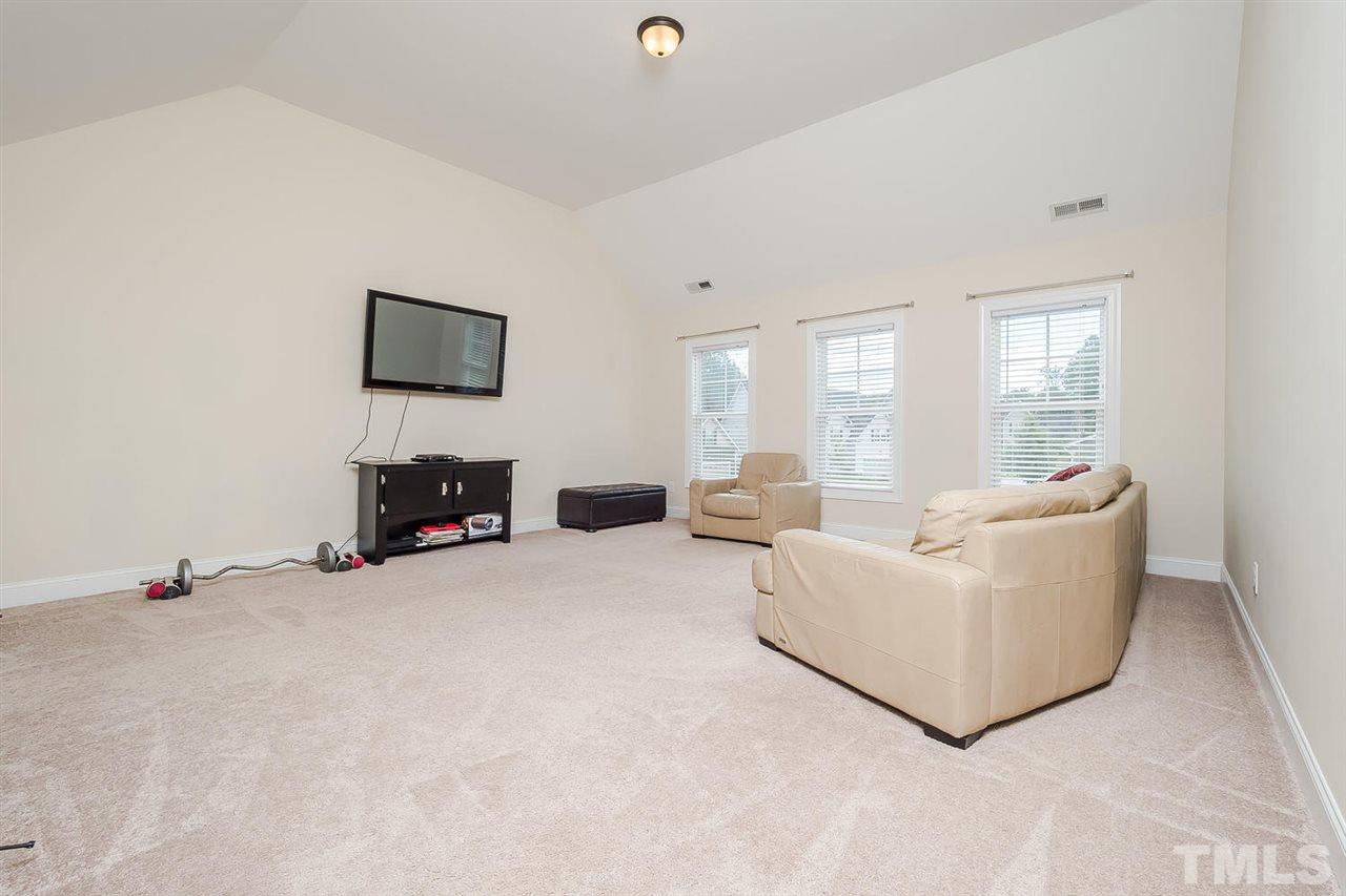 4436 Glengrove Road Raleigh, NC 27616 - Photo 18 of 25 a living room with furniture and a flat screen tv