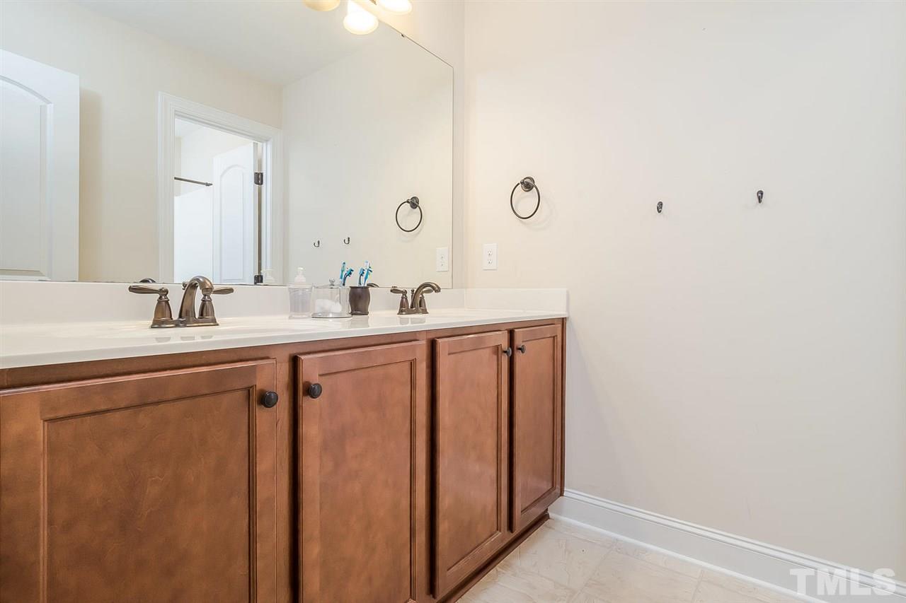 4436 Glengrove Road Raleigh, NC 27616 - Photo 19 of 25 a bathroom with a double vanity sink and a mirror