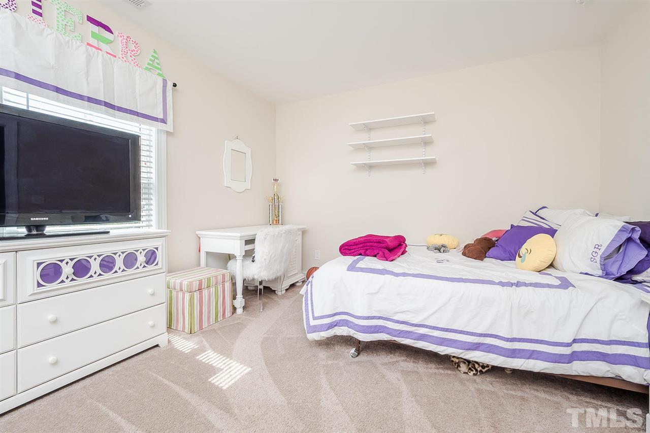 4436 Glengrove Road Raleigh, NC 27616 - Photo 22 of 25 a bedroom with a bed and flat screen tv