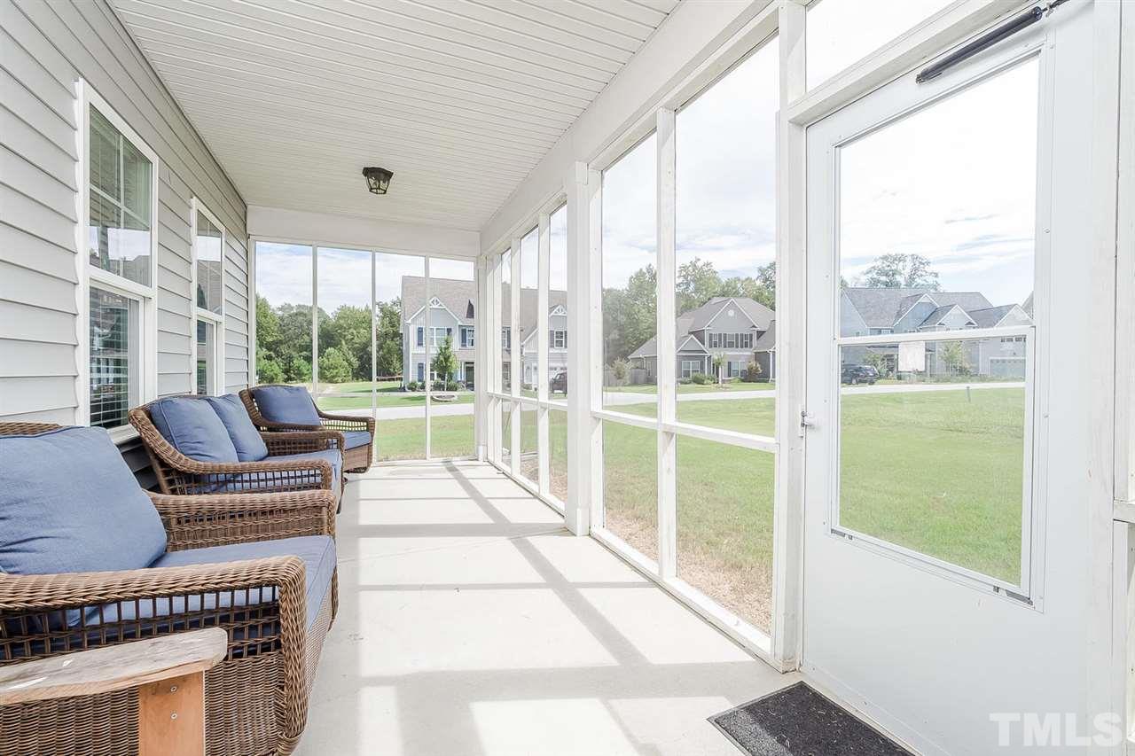 4436 Glengrove Road Raleigh, NC 27616 - Photo 23 of 25 a living room with furniture and a floor to ceiling window