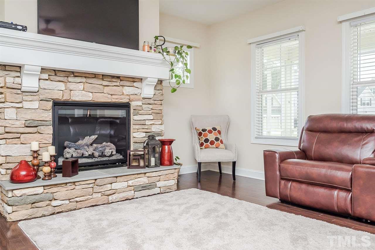 4436 Glengrove Road Raleigh, NC 27616 - Photo 5 of 25 a living room with furniture and a fireplace