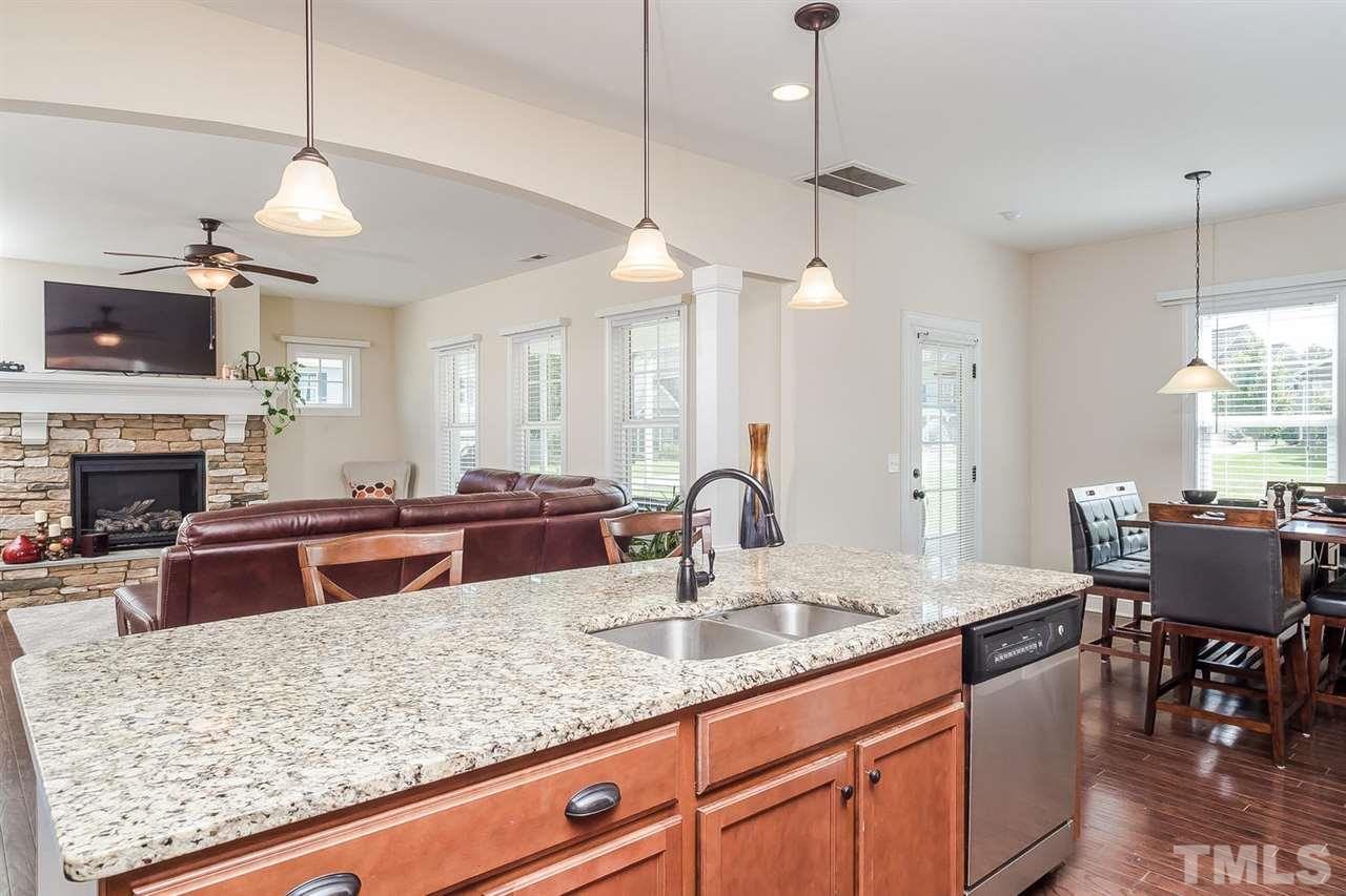 4436 Glengrove Road Raleigh, NC 27616 - Photo 9 of 25 a kitchen with granite countertop a sink a counter space appliances and cabinets
