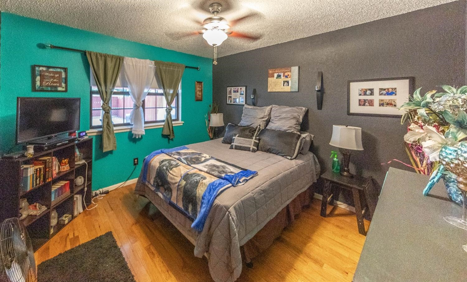 5722 2nd Place Lubbock, TX 79416 - Photo 11 of 21 a bedroom with a bed and a flat screen tv