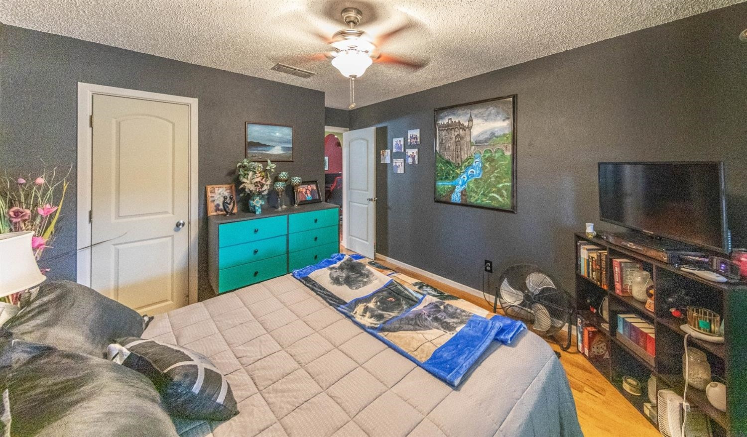 5722 2nd Place Lubbock, TX 79416 - Photo 12 of 21 a bedroom with a bed and flat screen tv