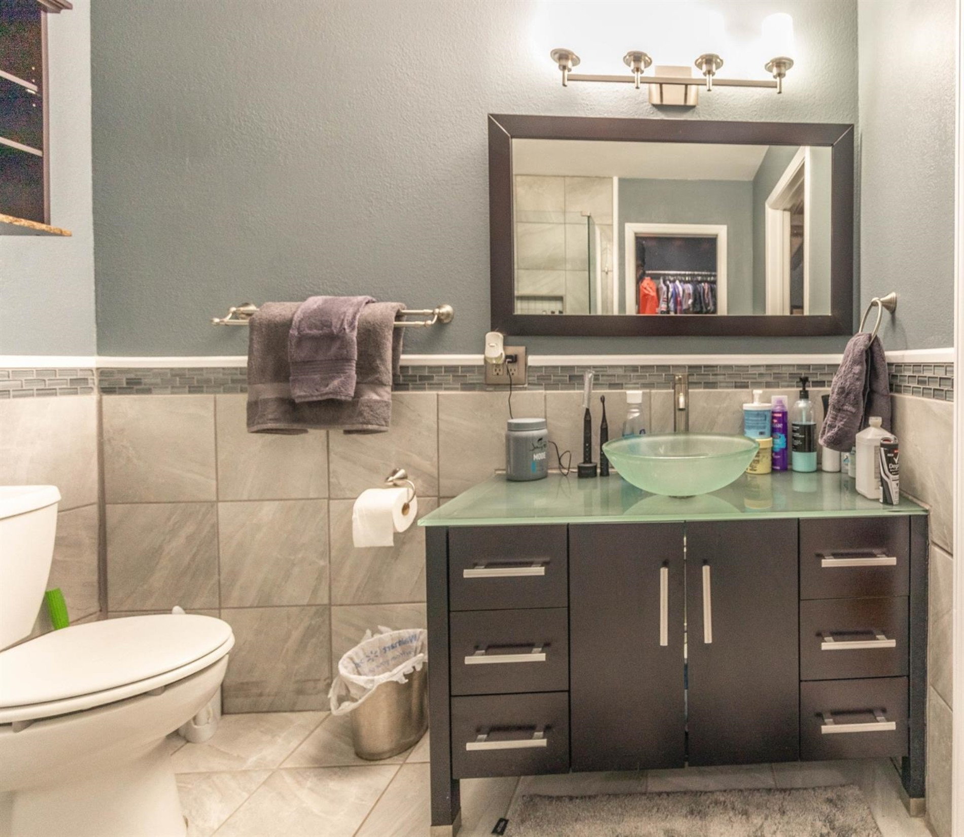 5722 2nd Place Lubbock, TX 79416 - Photo 14 of 21 a bathroom with a toilet sink and mirror