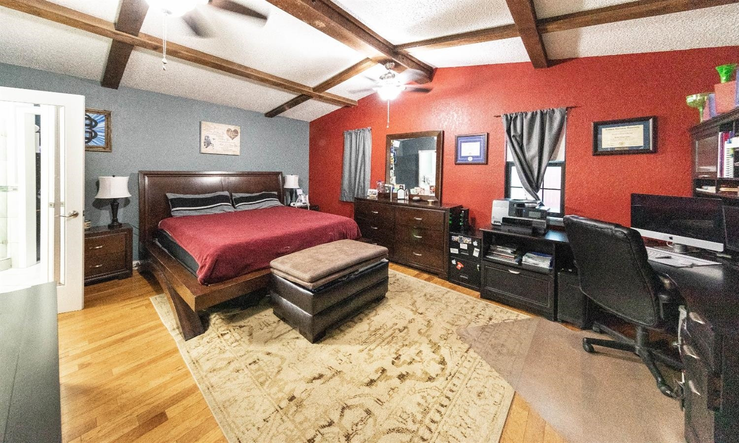 5722 2nd Place Lubbock, TX 79416 - Photo 15 of 21 a bedroom with a bed lamp and dresser